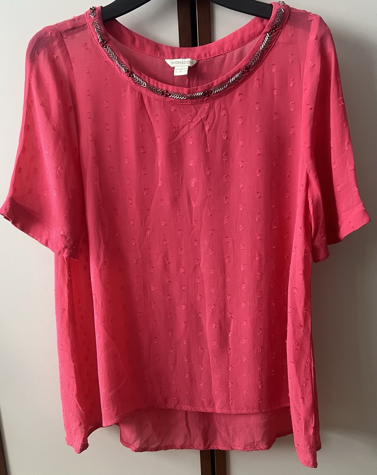 Women’s top in pink with bedded details around neckline size 8