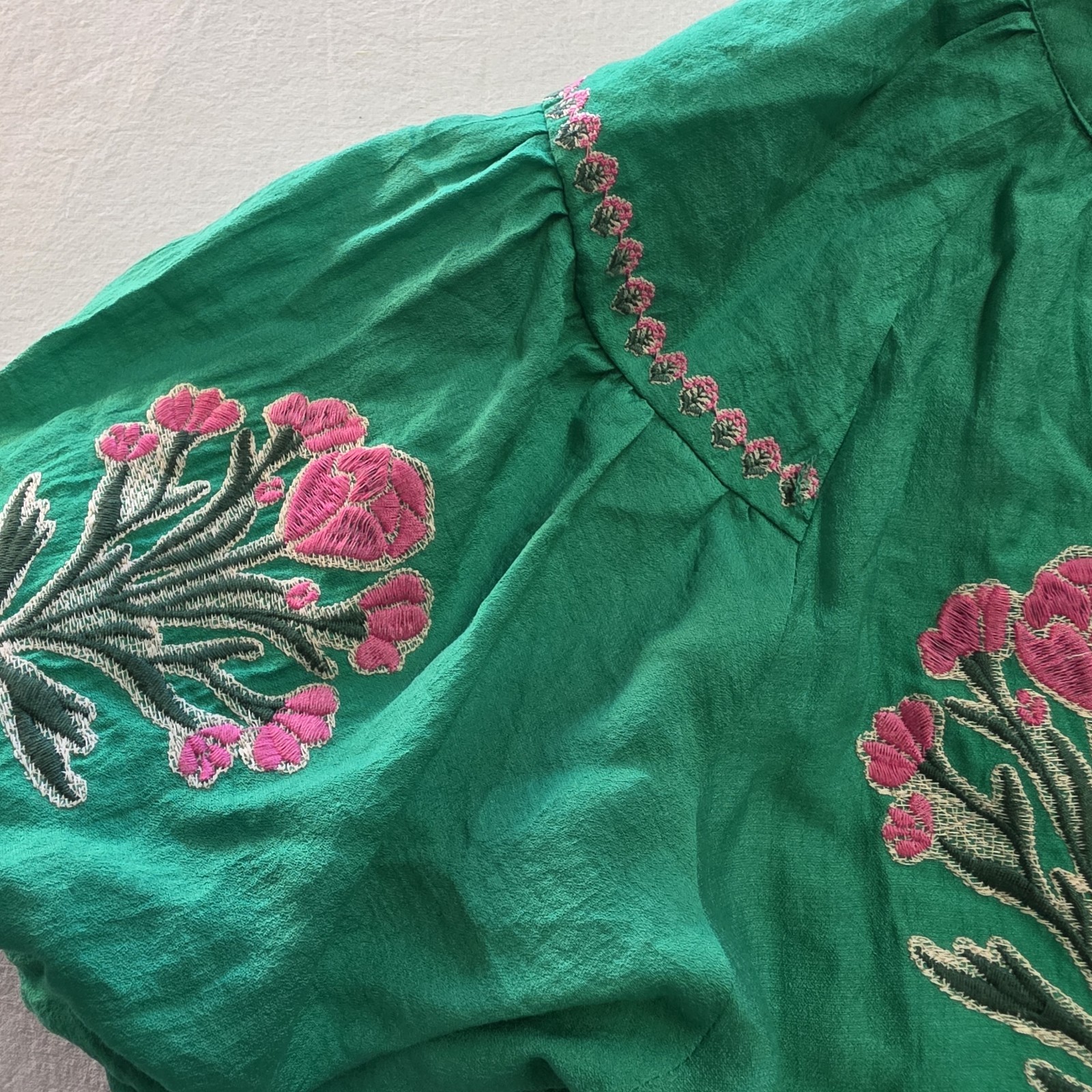 Umgee green dress features distinct floral embroidery and a charming drop waist
