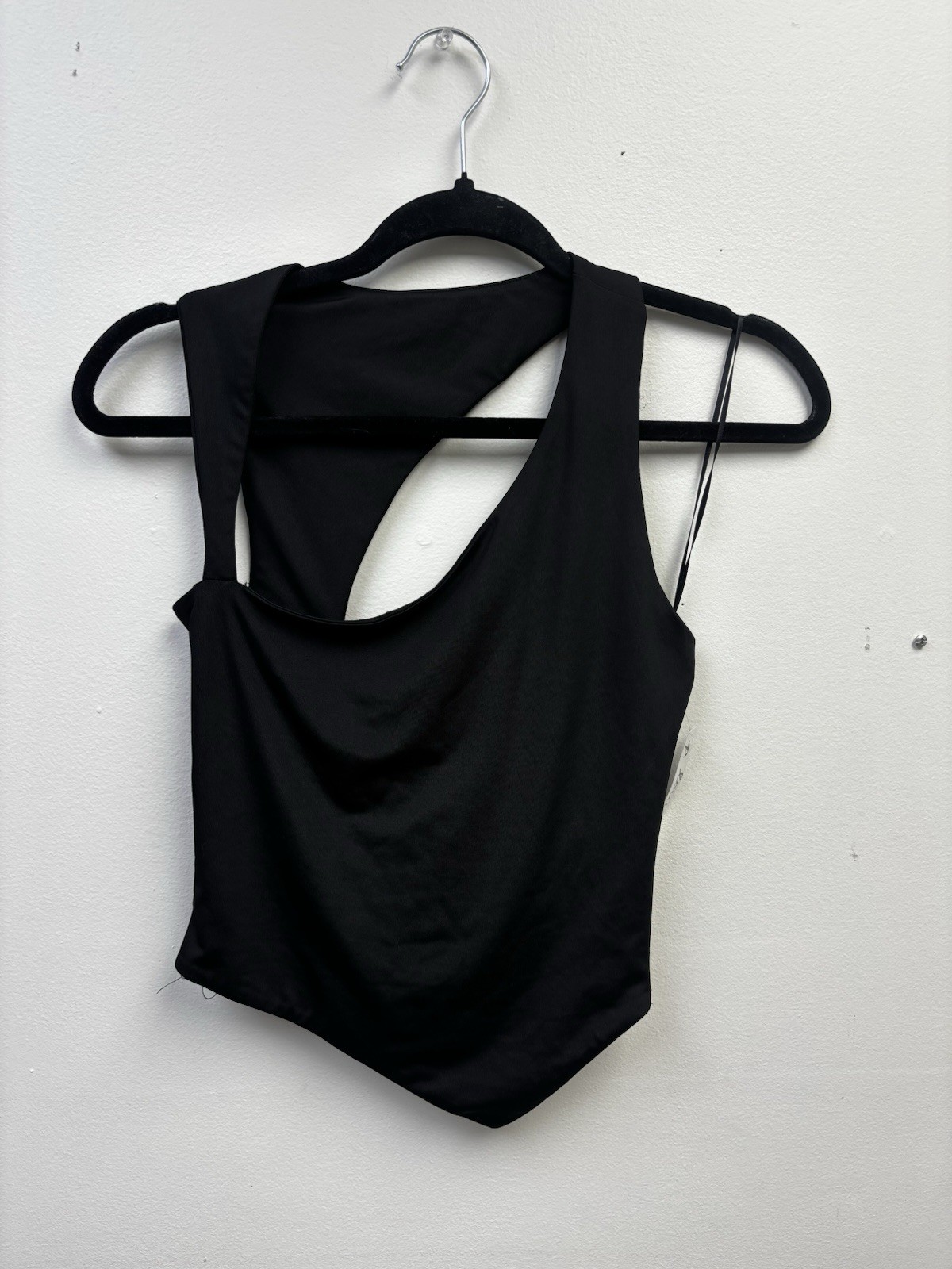 black one-shoulder cutout Top features a distinct asymmetrical