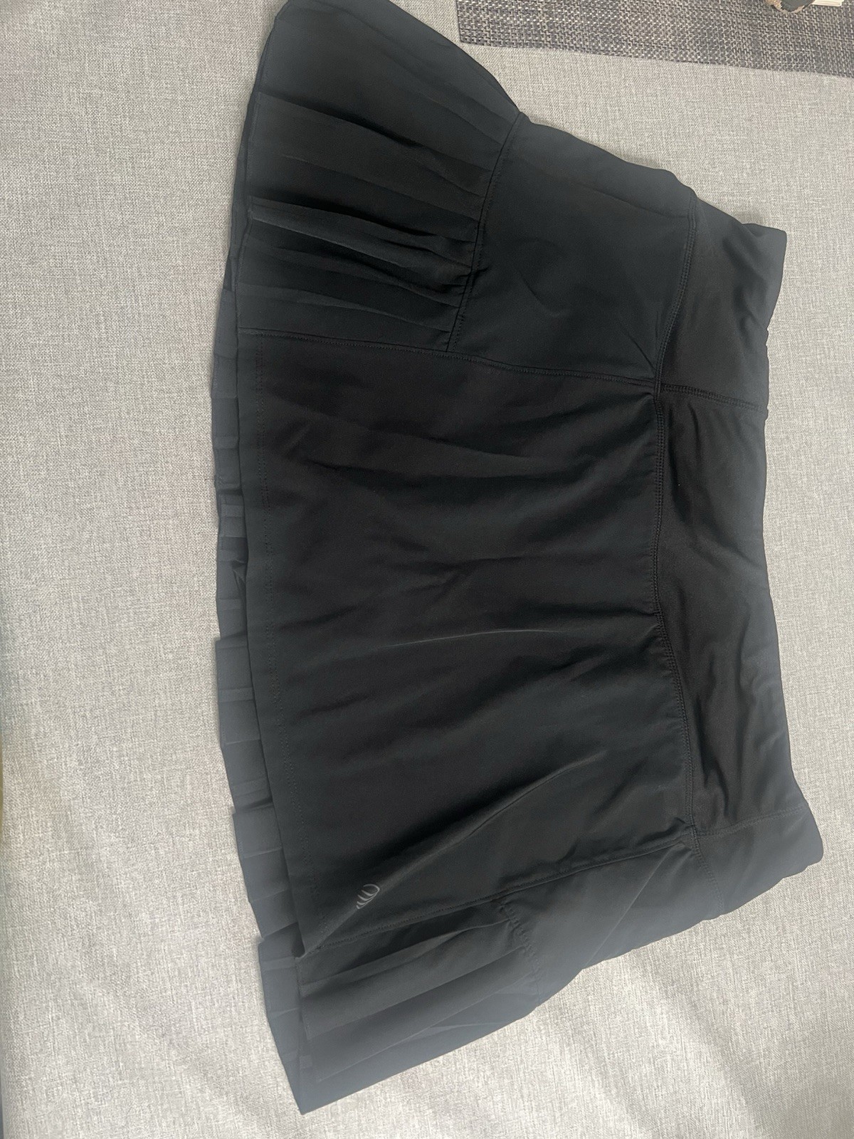 MPG branded black mini tennis Skirt With Built In Shorts. Smooth stretch fabric.