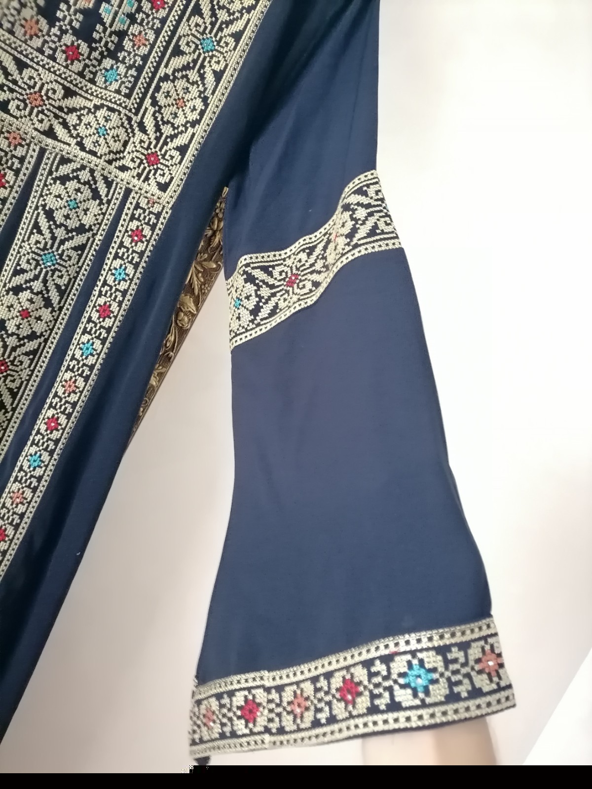 Navy thobe with old Arabic embroidery, distinctive with a floral design