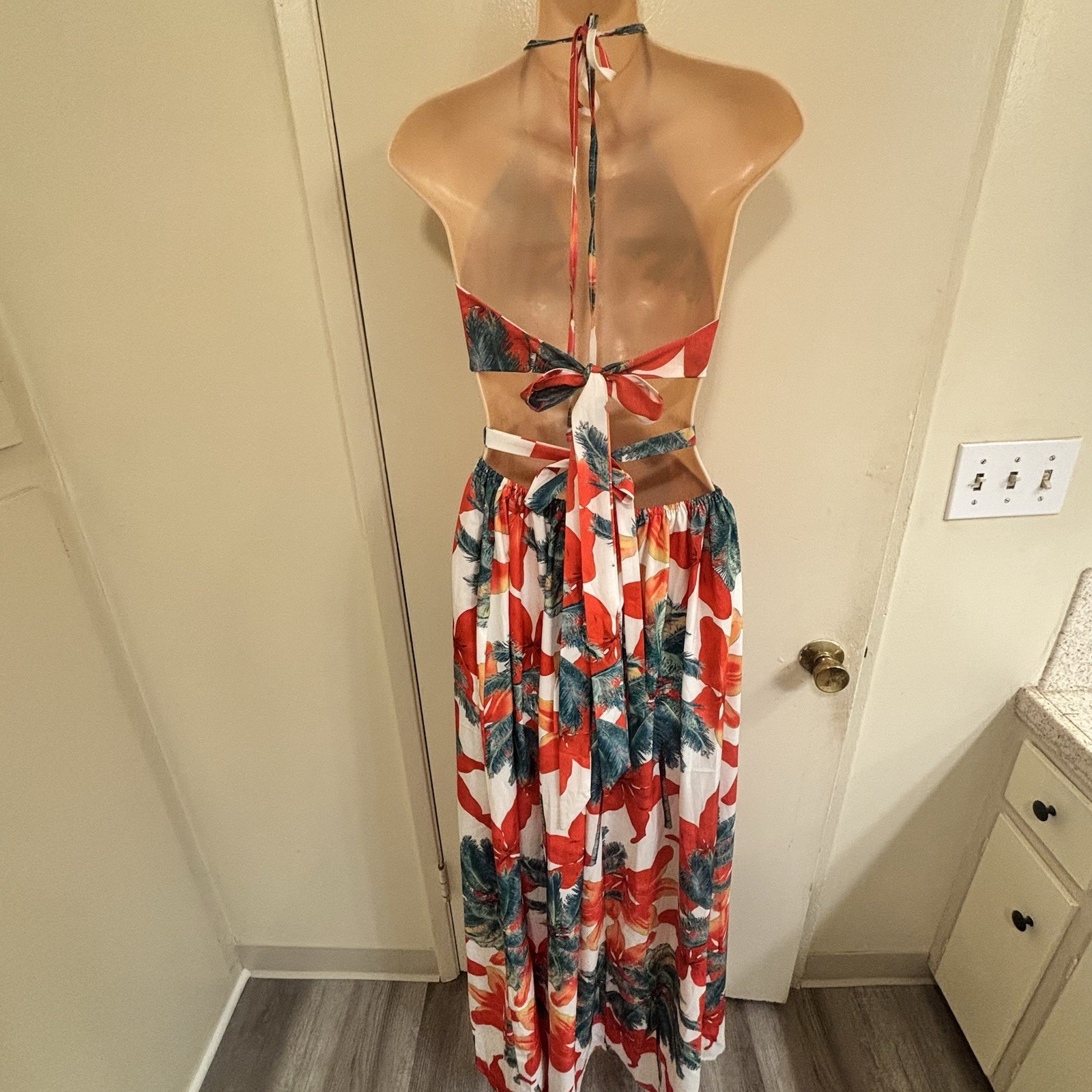 BeachCore tropical print halter maxi dress featuring gold chain cut-out details.