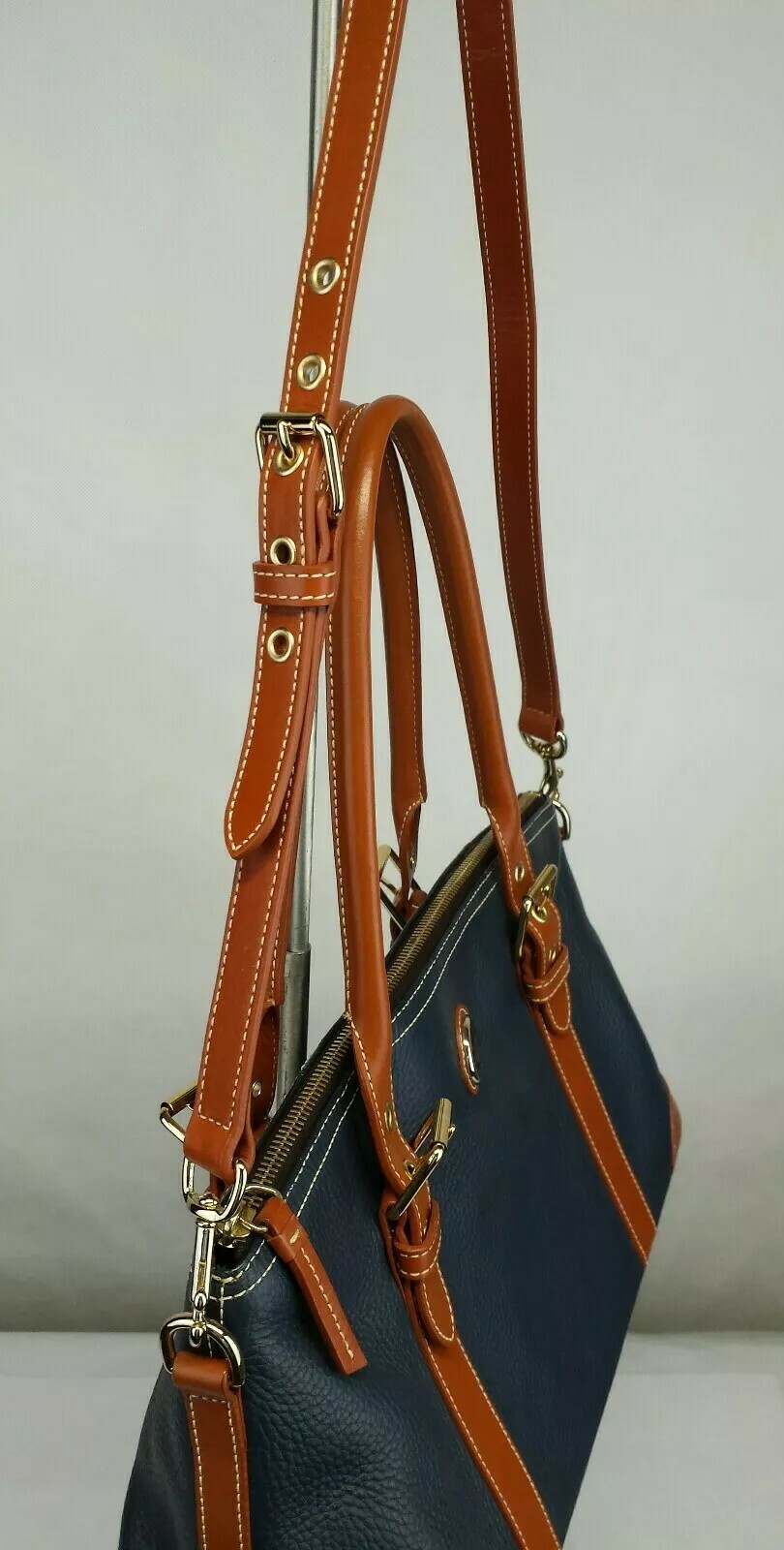 Dooney & Bourke Hand Bag golden hardware Color Navy Blue-cognac In Very Good C.