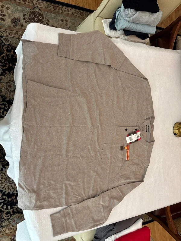 Grey long sleeve Wrangler work shirt. Front pocket with utility hook. Brand new