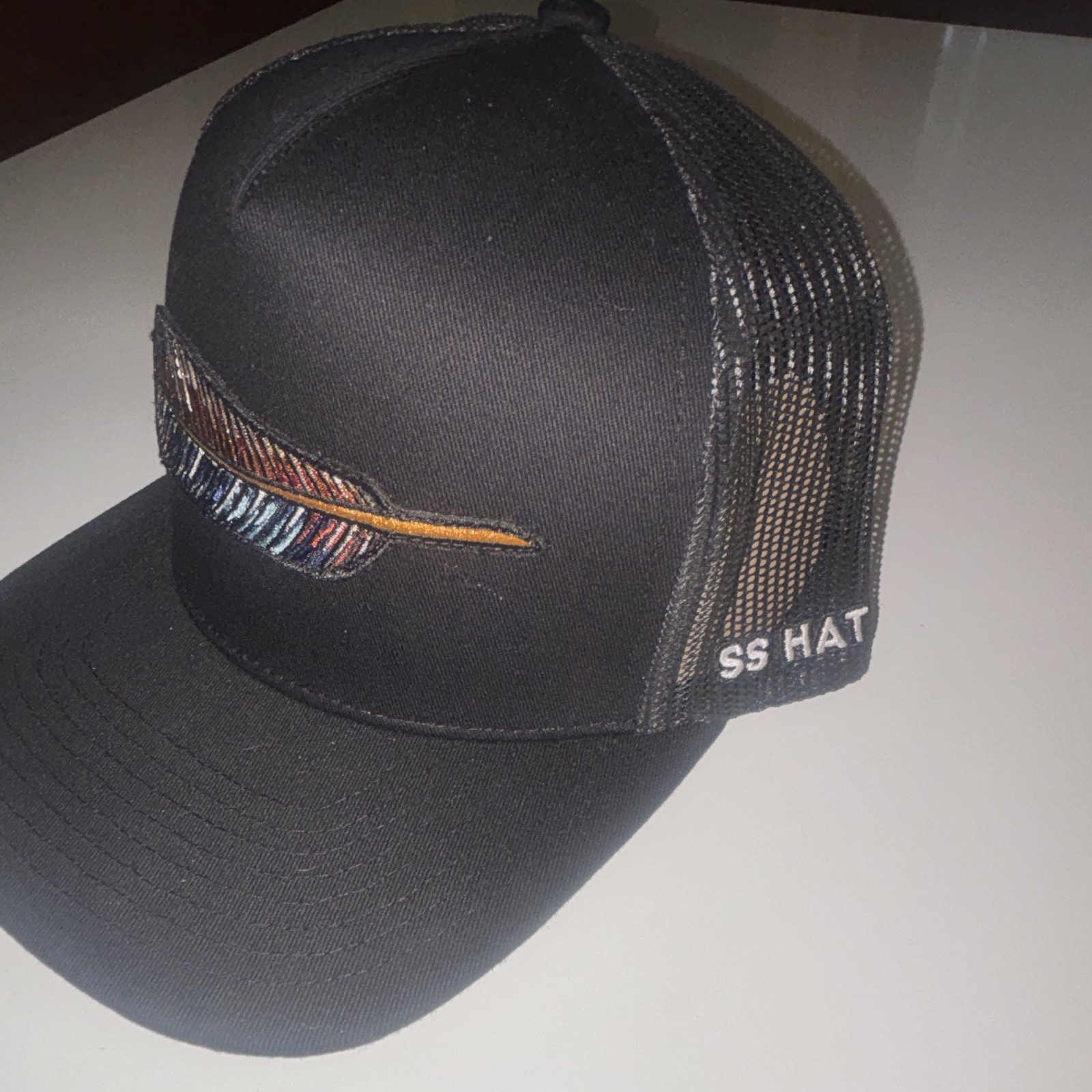 SS HAT Black Trucker Hat Mesh Back Feather Patch One Size Unisex Adults