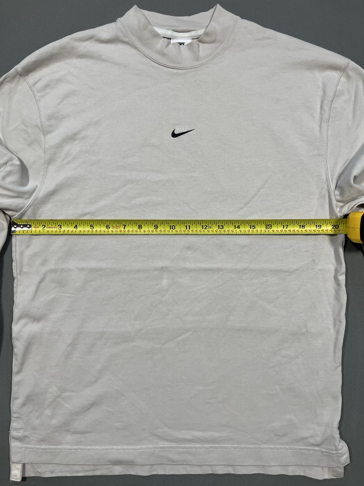 Nike long sleeve mock neck top in Light Bone featuring a small swoosh logo